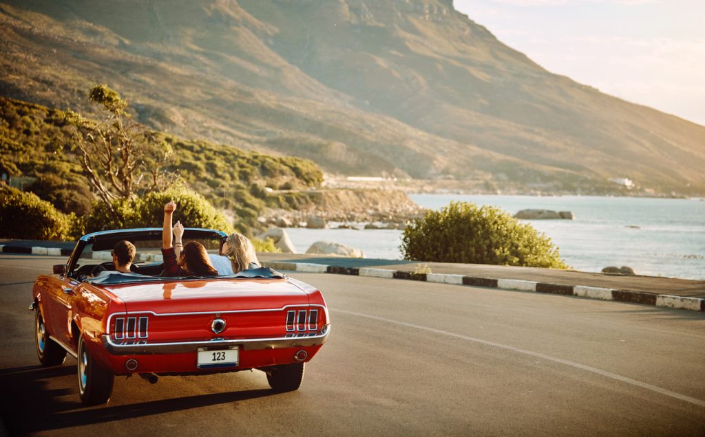 Shot of happy young friends enjoying a summer’s road trip together