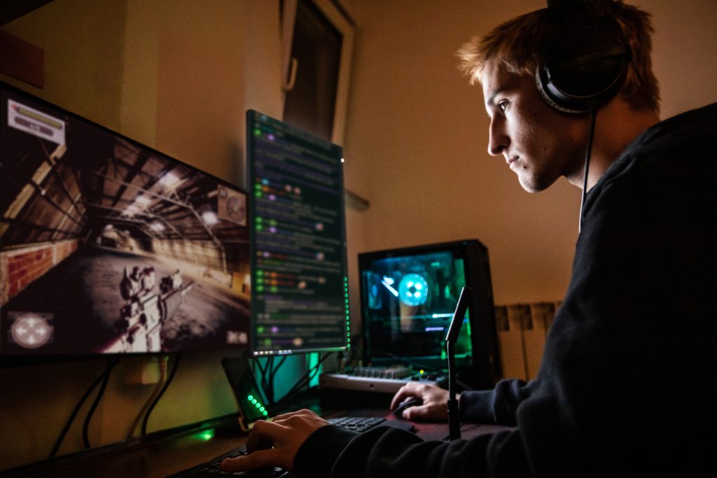 Teenage Boy Playing Multiplayer Games on Desktop Pc in his Dark Room